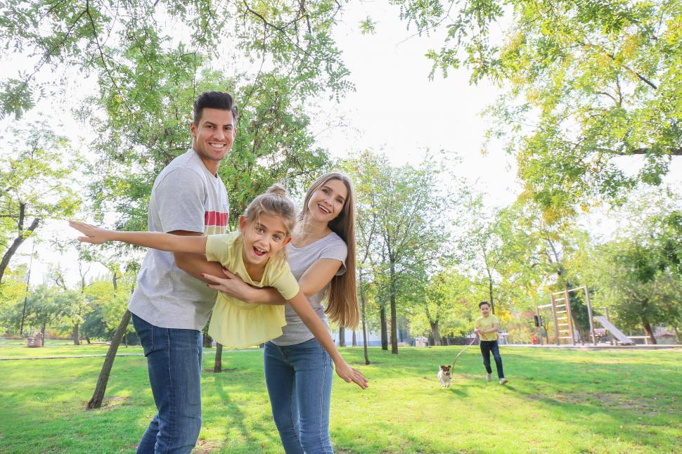 Happy family playing outside of home